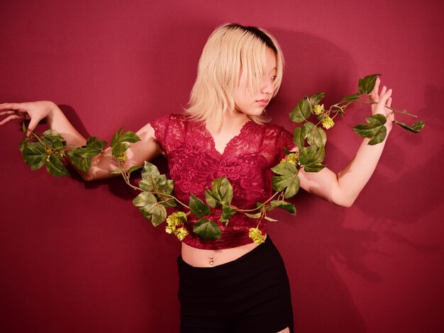 Midsection of woman holding red flower