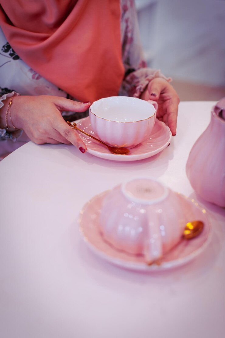 Photo テーブルの上でお茶のカップを握っている女性のミッドセクション