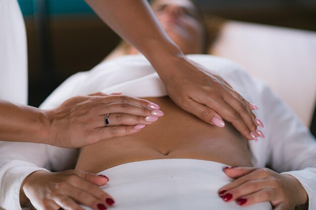 Midsection of woman lying on bed