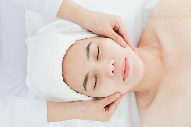 midsection of woman massaging customer lying on table