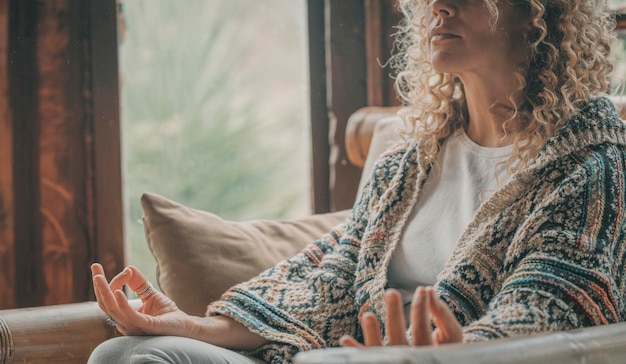 midsection of woman meditating at home