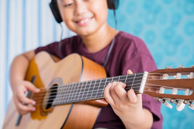 Midsection of woman playing guitar