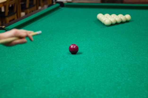 Midsection of woman playing pool