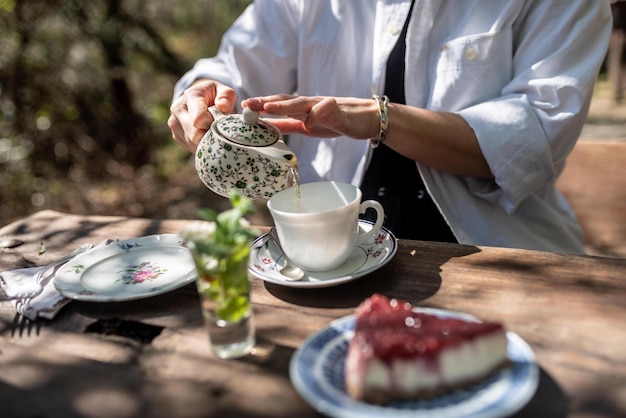 Photo midsection of woman pouring coffee in cup