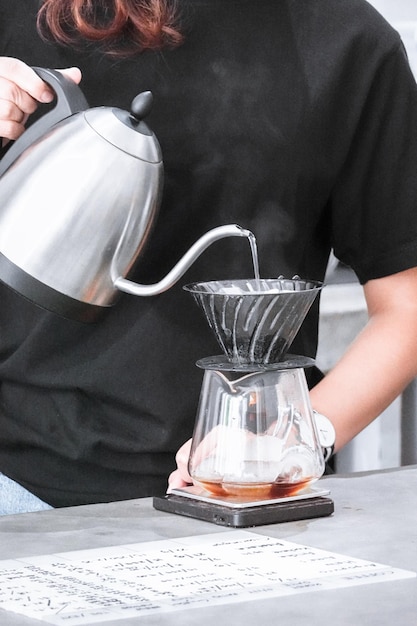 Midsection of woman pouring coffee