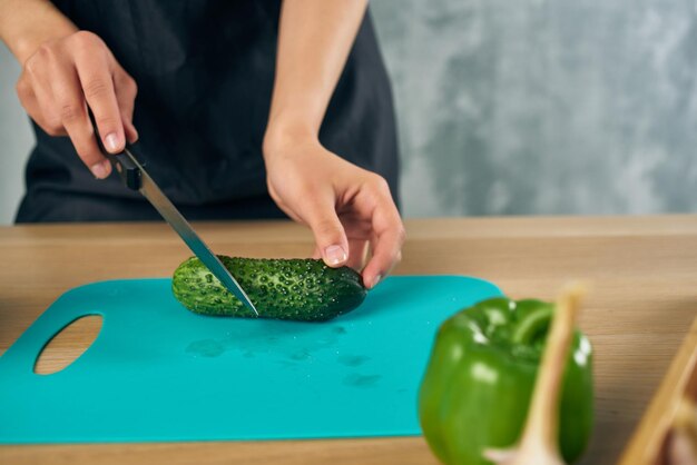 Midsection of woman preparing food on cutting board