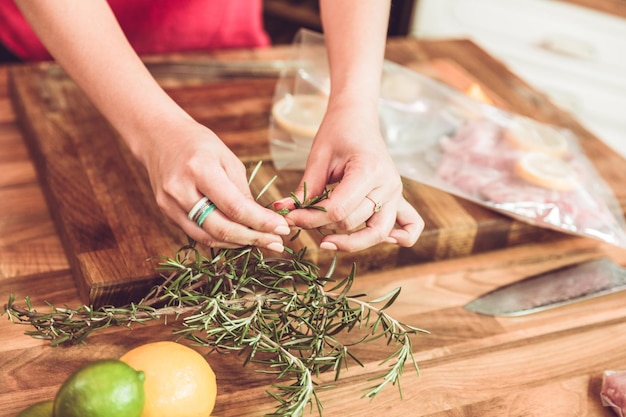 Midsection of woman preparing food on cutting board