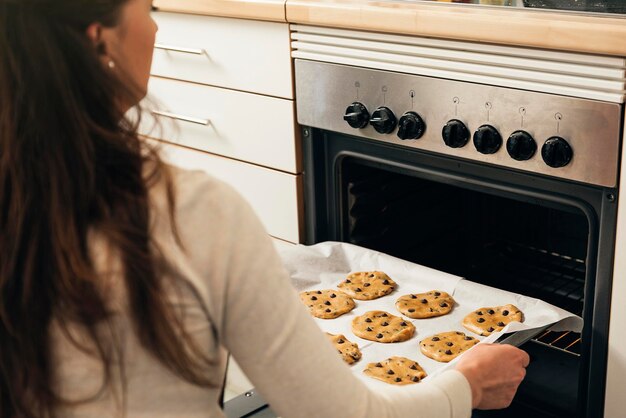 Midsection of woman preparing food at home