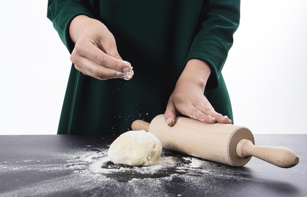 Midsection of woman preparing food on table against white background