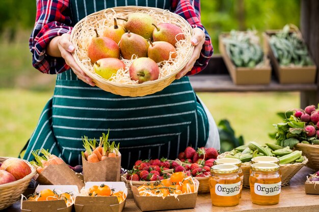 Midsection of woman selling pears