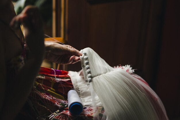 Photo midsection of woman sewing buttons