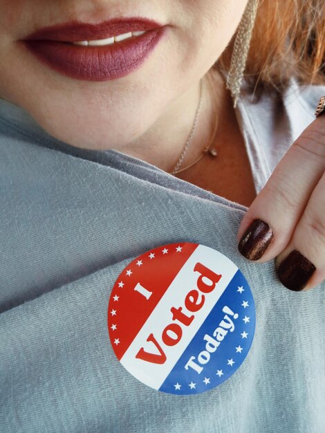 Photo midsection of woman showing i voted today badge on top