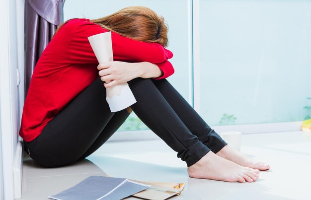 Midsection of woman sitting on wall