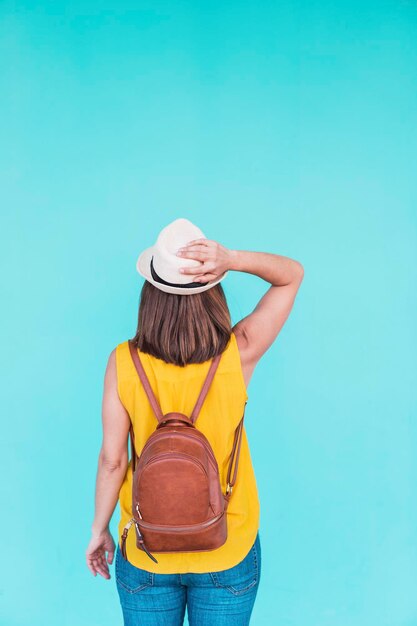 Midsection of woman standing against blue wall