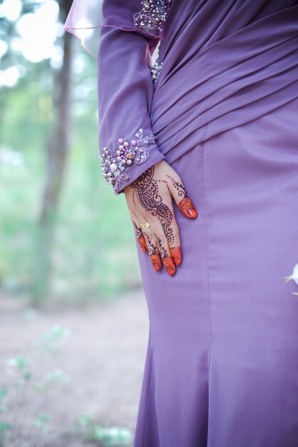 Midsection of woman standing against blurred background