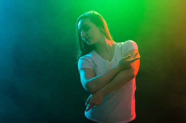 Midsection of woman standing against gray background