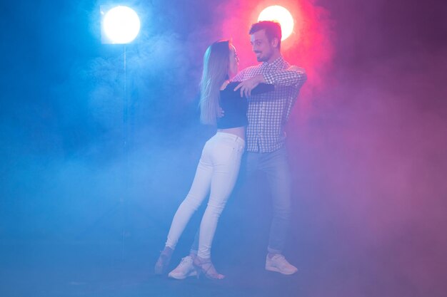 Midsection of woman standing against illuminated light at night