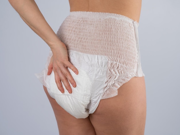 Midsection of woman standing against white background