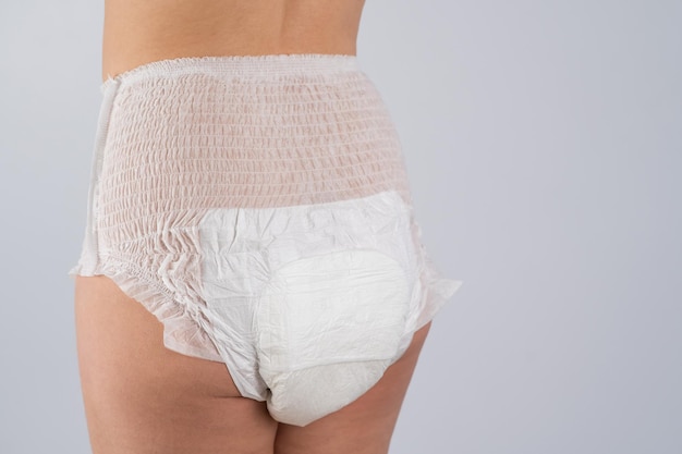 midsection of woman standing against white background