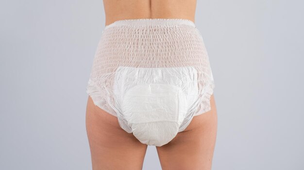 midsection of woman standing against white background