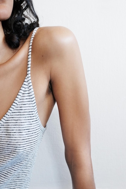 Midsection of woman standing against white background