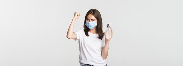 Midsection of woman standing against white background