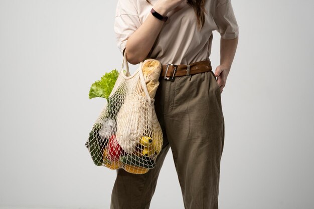 Midsection of woman standing against white background