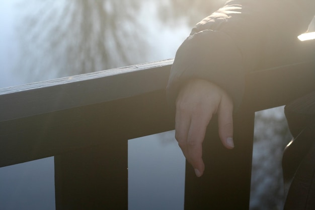 Midsection of woman standing by railing