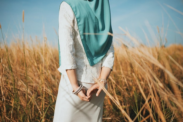 midsection of woman standing on field against sky