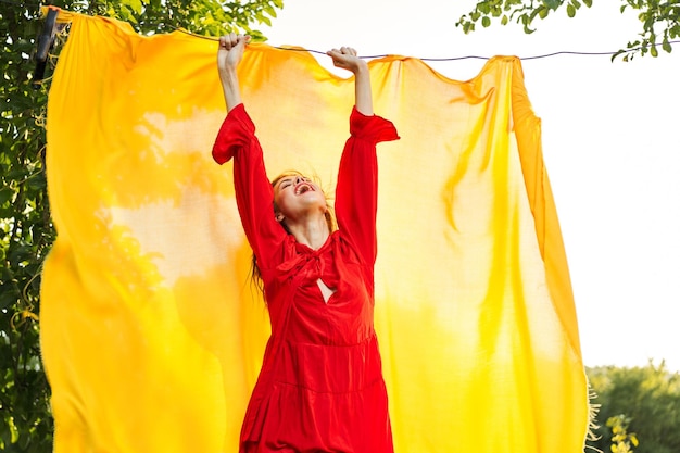 Midsection of woman standing with yellow umbrella