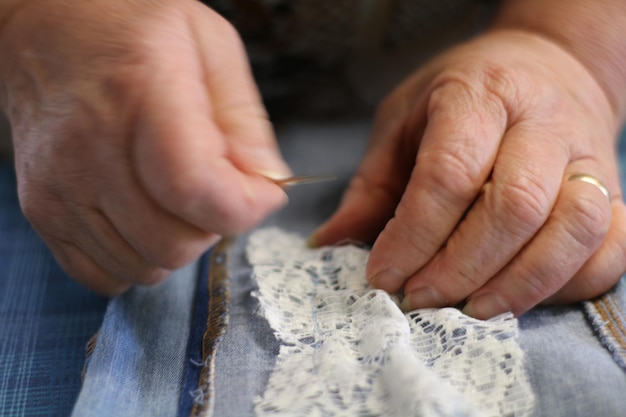 midsection of woman stitching fabric