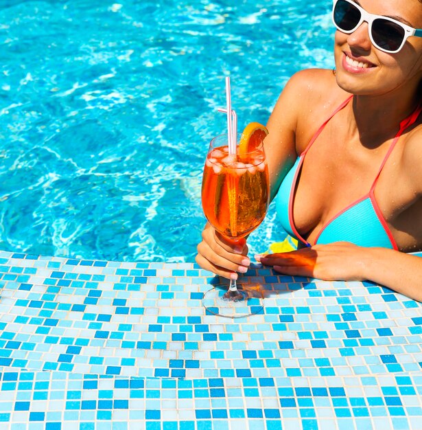 Midsection of woman at swimming pool