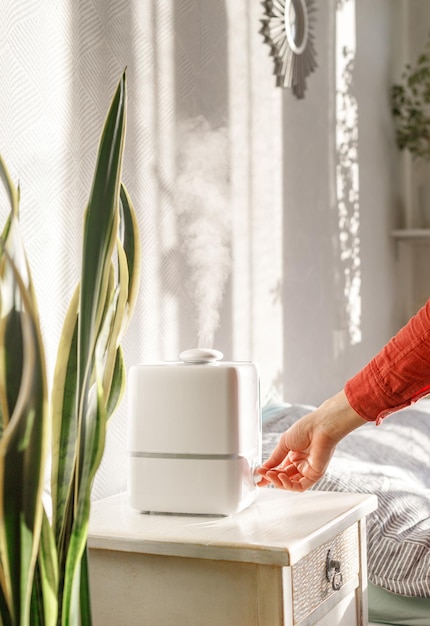 Photo midsection of woman at table by window at home