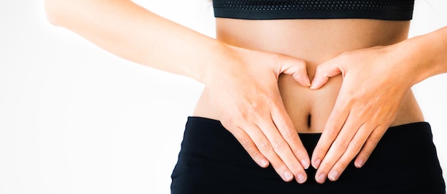 Midsection of woman touching hair against white background