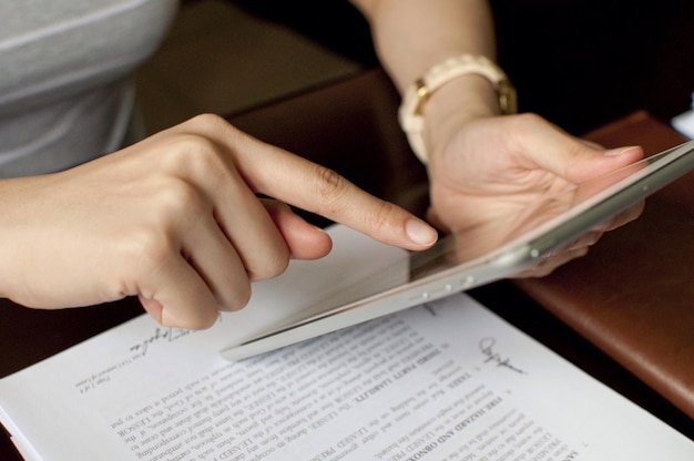 Photo midsection of woman using digital tablet at home