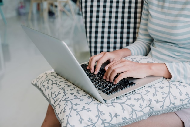 midsection of woman using laptop