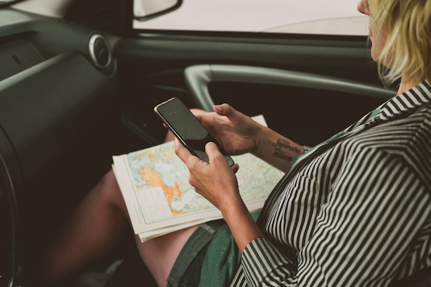 Photo midsection of woman using mobile phone in car