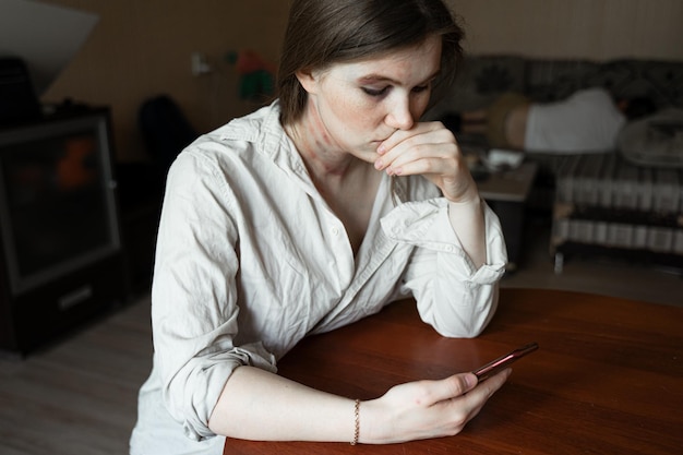 midsection of woman using mobile phone at home