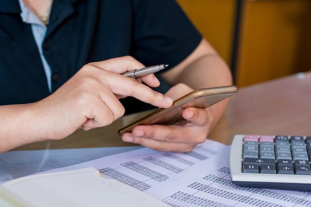 midsection of woman using mobile phone on table
