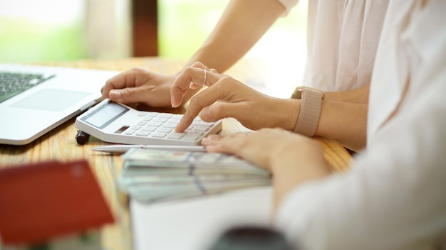 Midsection of woman using mobile phone on table