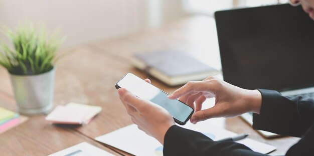 Midsection of woman using mobile phone