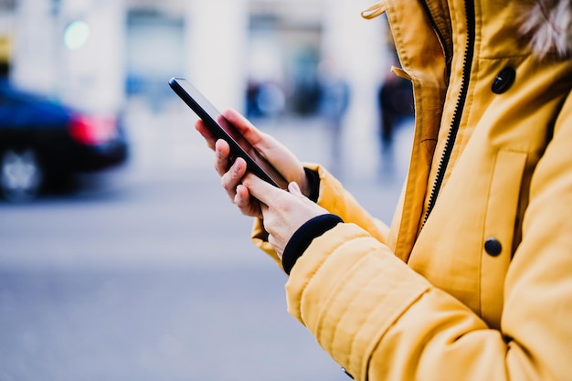midsection of woman using mobile phone