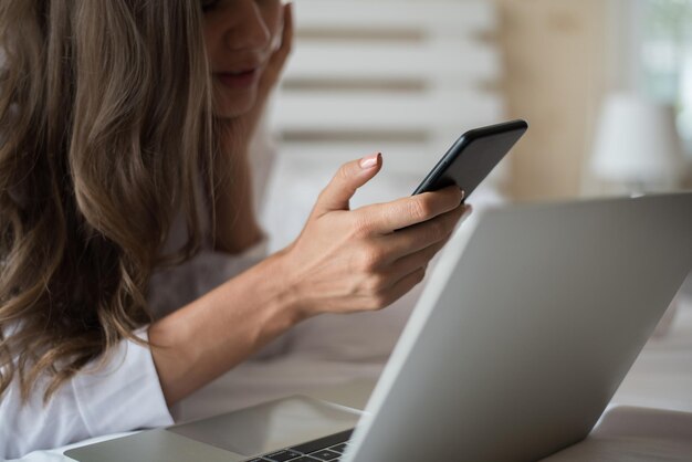 Midsection of woman using mobile phone