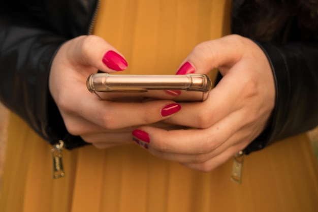 Midsection of woman using mobile phone