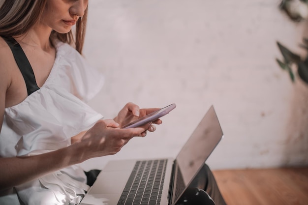 Midsection of woman using mobile phone