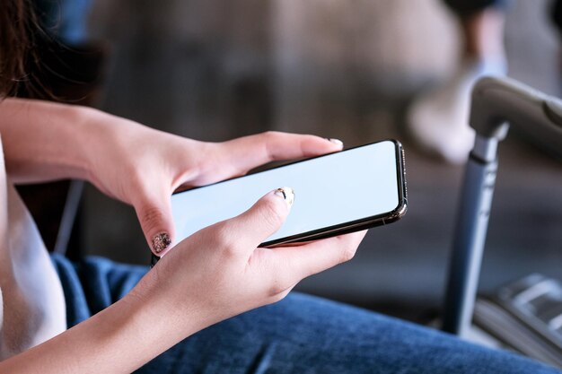 Midsection of woman using mobile phone