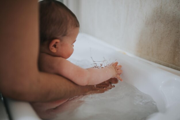 Photo midsection of woman with child in bathtub at home