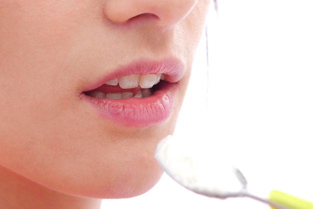 Photo midsection of woman with food in spoon against white background