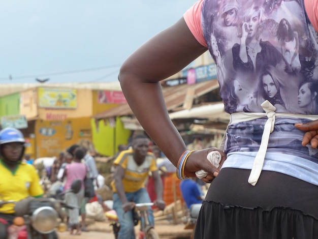 midsection of woman with hand on hip in city