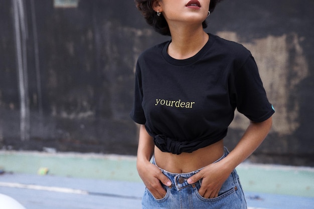 Photo midsection of woman with text on t-shirt standing outdoors